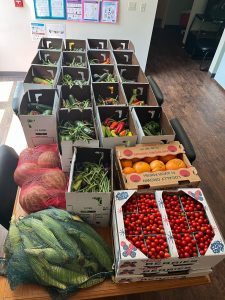 Several boxes of fresh produce on a table.