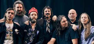 The seven members of the indie rock band The War On Drugs pose together. 