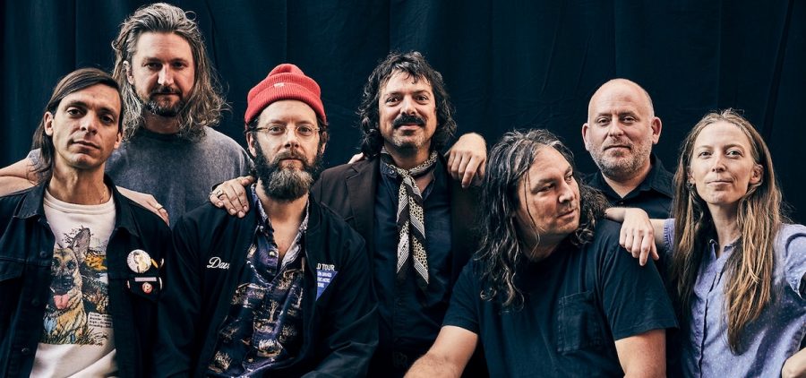 The seven members of the indie rock band The War On Drugs pose together.