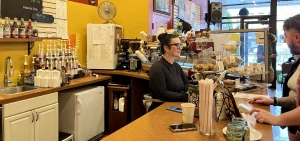 An employee at Cafe Amici takes a customer's order.