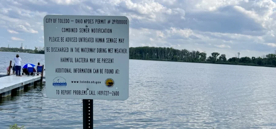 A sign at a beach in Toledo warns people about the risk of harmful bacteria like algal blooms in Lake Erie.