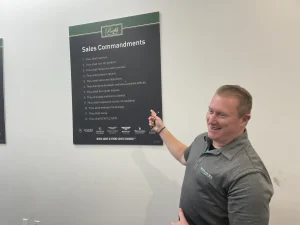 A man points out "sales commandments" that Moreno created when he was the owner of the dealership.