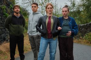 Four characters from Ridley facing the camera standing in a roadway