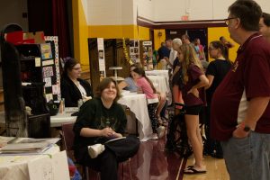 Students present to a large crowd of visitors in the gymnasium of Federal Hocking High School.