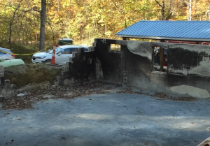 Two walls of the Rehobeth Church. One wall has a giant, crumbling hole. There's burn marks all over from the fire. 