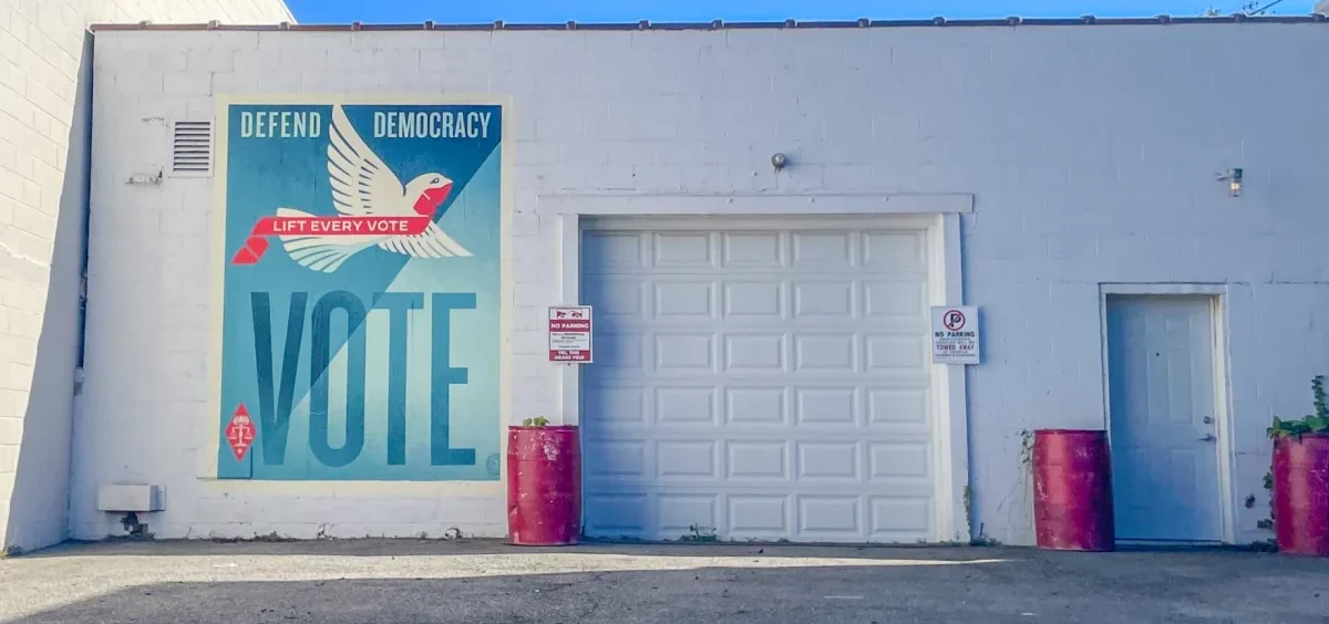 A temporary wheat paste poster by street artist and activist Shepard Fairey is on a building in downtown Columbus.