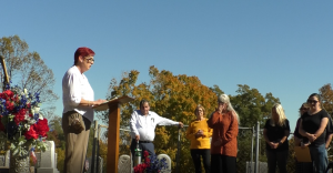 Jodie Fowler speaks at a podium in front of her old church--Fox Fairview in Gallia County. There's nothing left to the church but ashes. 