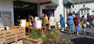 People stand in line outside for food