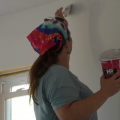 A Habitat for Humanity volunteer brushes primer onto the walls of an unfinished house in Glouster. Once the home is completely finished, it will be ready for the new homeowner to move in.