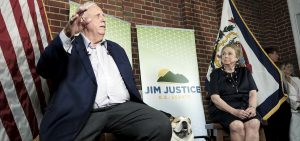 West Virginia Gov. Jim Justice speaks, as his dog named "Babydog" and wife Kathy Justice listen at an election night watch party at the governor's mansion