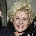 Brenda Lee smiling with her Rock And Roll induction award. Credit: Getty Images