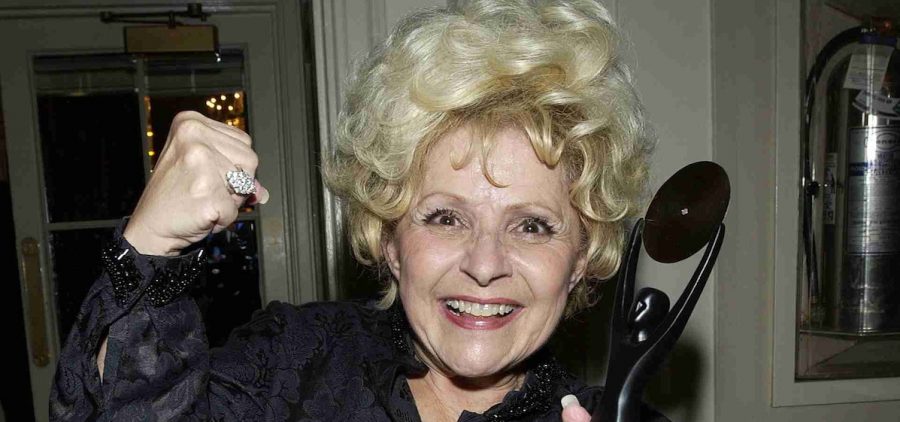 Brenda Lee smiling with her Rock And Roll induction award. Credit: Getty Images