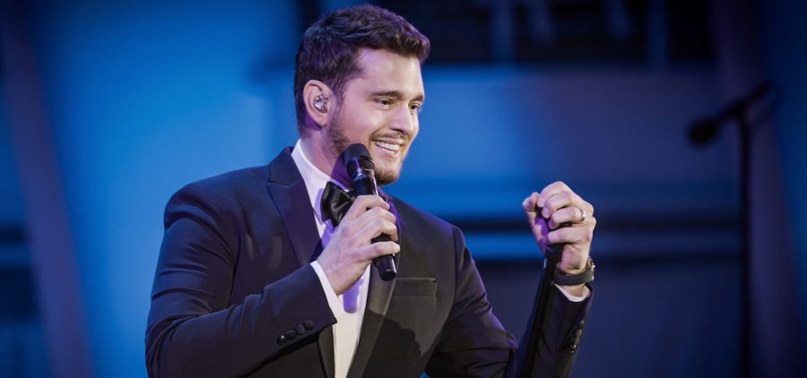 Michael Buble holding mic singing on stage