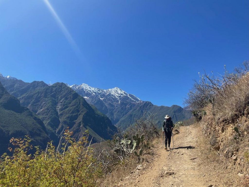 An image of Christopher Fiorello walking on a mountainside. 