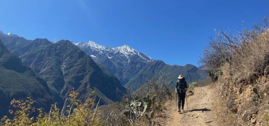 An image of Christopher Fiorello walking on a mountainside.