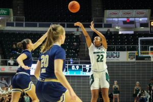 Asiah Baxter taking a three-pointer against George Washington. 