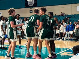 AJ Clayton (#23) picking up Aidan Hadaway (#10) after being fouled. 