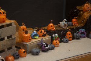 A collection of student-made pumpkin sculptures, some made of ceramic and others made through 3D printing.