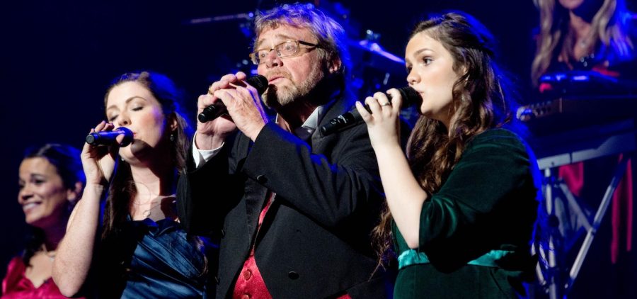 close up of three singers from Mannheim Steamroller 30/40 Live on stage performing