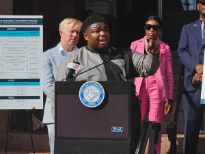 Rep. Dontavius Jarrells speaks in Cincinnati behind a podium.