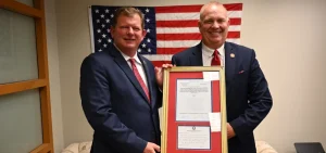 Jason Stephens presents a framed declaration to Tim Barhorst.