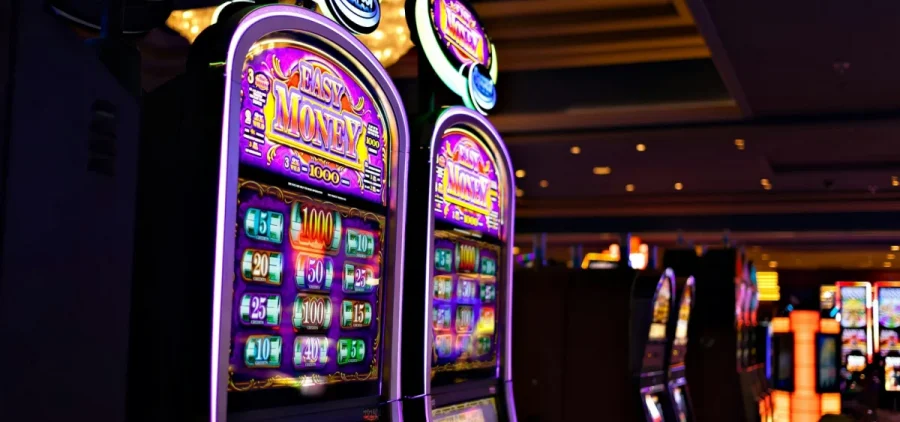 Two video slot machines on a casino floor.