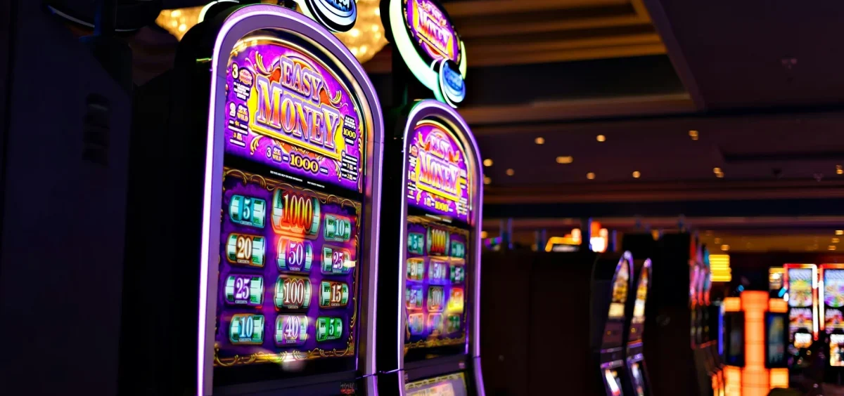 Two video slot machines on a casino floor.