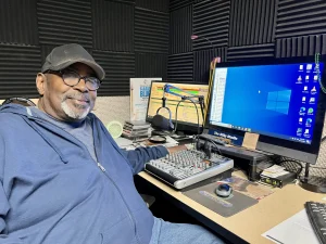 "Silky Ray" Macklin picks out blues songs to broadcast from the radio station in Marion.