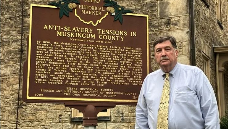 A picture of Peter Cultice by the historical marker at Stone Academy.