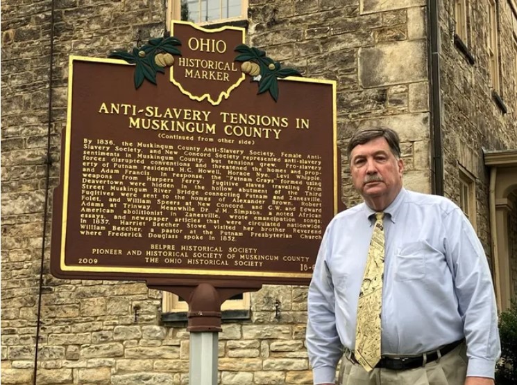 A picture of Peter Cultice by the historical marker at Stone Academy.