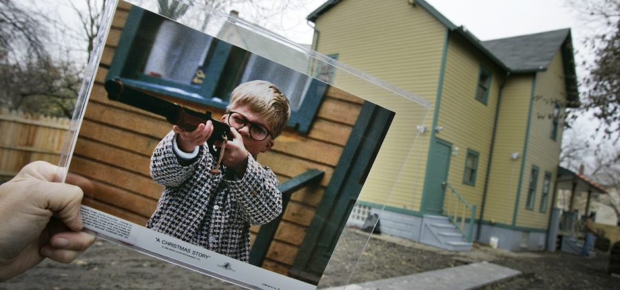 A photo of the character Ralphie, played by actor Peter Billigsley, firing his Red Ryder air rifle from the classic movie "A Christmas Story" is held in the back yard of the house used in the filming of the movie in Cleveland.