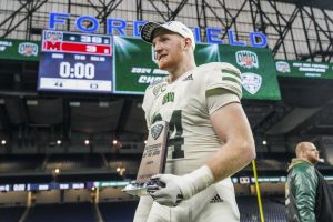 Bradley Weaver holding his defensive player of the game award after Ohio's 38-3 win over Miami. 