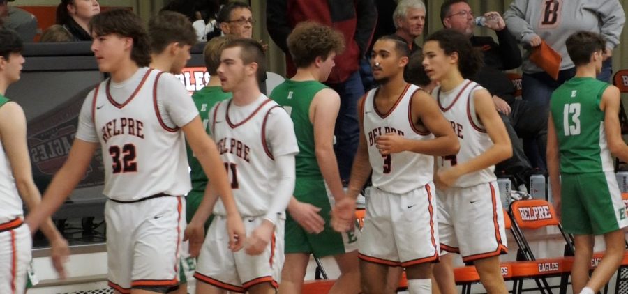 Belpre basketball players shaking hands on court with eastern basketball players