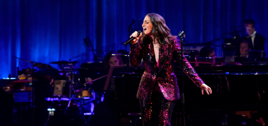 Sara Bareilles in dark pink glitter suit performing onstage