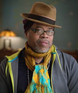 A man wearing a hat and scarf. 