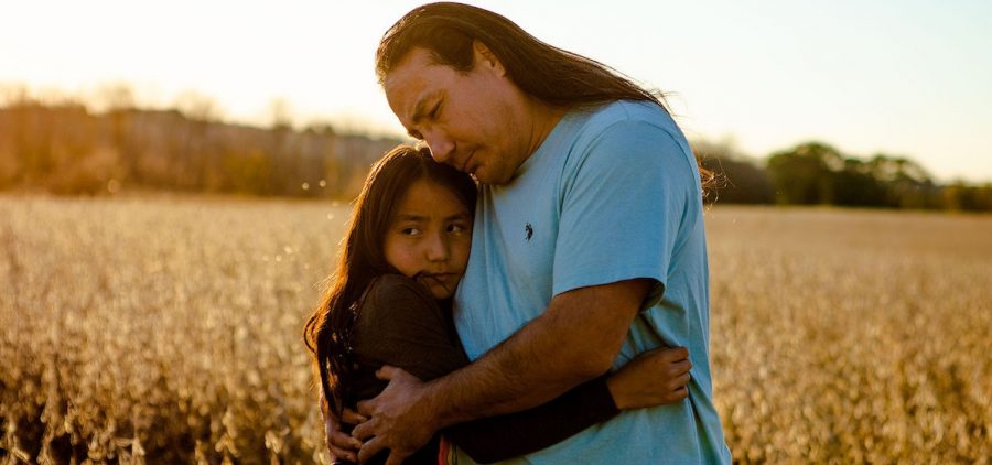 Fiddler Family, Green Grass, SD, 2011. father and daughter hugging in grain field