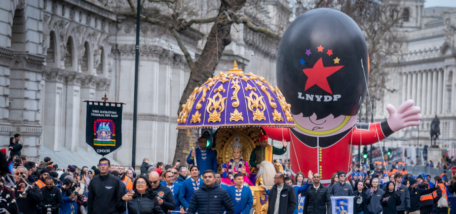 marchers and a police parade balloon as a part of a new years day parade in London