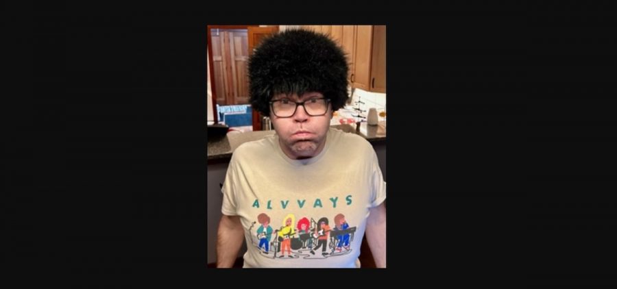 A picture of a man wearing a wig and an Alvvays t-shirt.