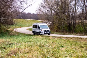 An autonomous vehicle drives on a rural road.