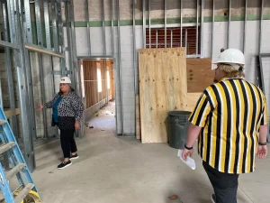 Cynthia Bonidie (left) and Brandon Barnes of Homeward Bound in what would soon become the living room area of the day center and severe weather shelter as it was under construction in October 2024.