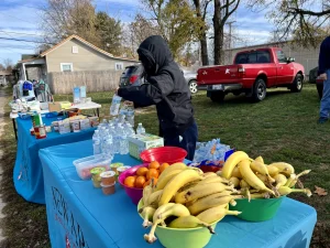 A volunteer sets up a table of food options at Newark Homeless Outreach's Saturday morning event in November.