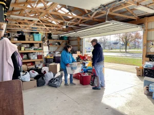 Trish Perry talks to a volunteer as she begins setting up for Newark Homeless Outreach's Saturday morning food drive.