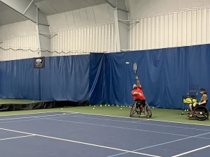 Jacob Counts serves a tennis ball at practice in early November.