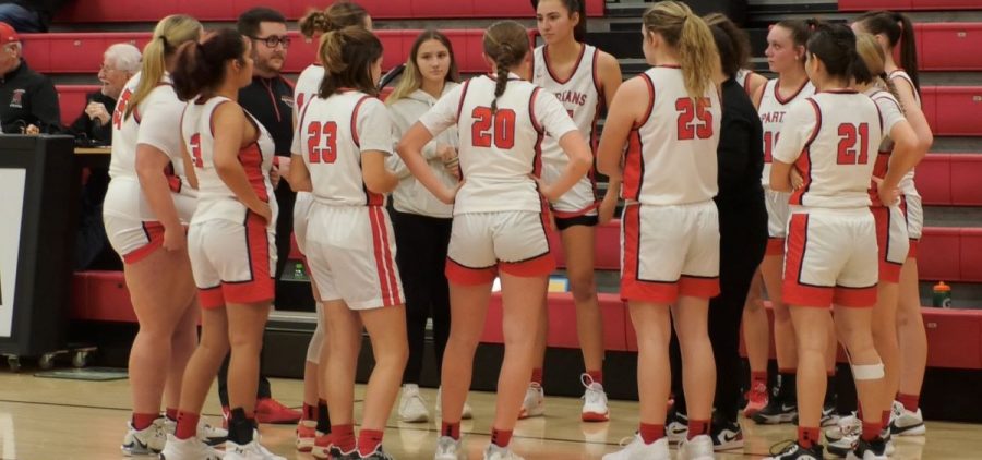 Alexander girl basketball players stand on court