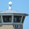 A prison watchtower against a blue sky.