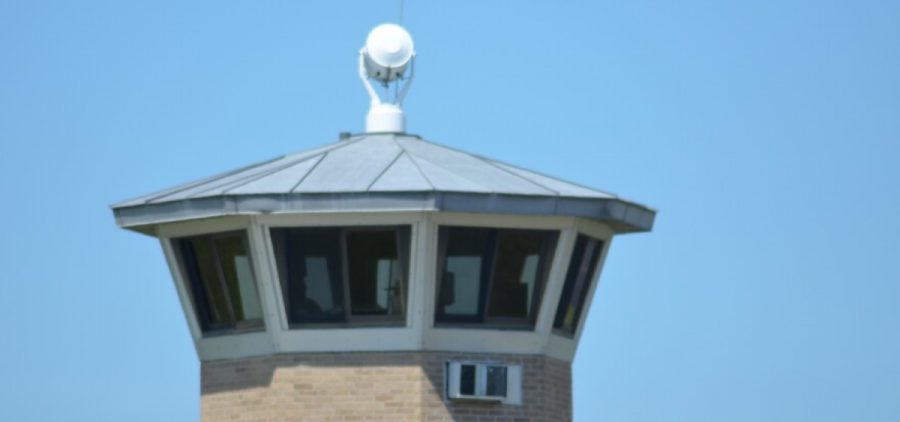 A prison watchtower against a blue sky.