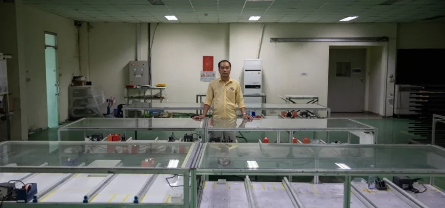 Nguyen Quoc Chinh, factory director of Red Sun Energy’s plant outside Ho Chi Minh City, stands in an empty production room that is no longer in use due to reduced sales.