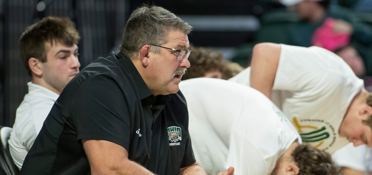 Ohio Wrestling head coach Joel Greenlee on the bench during the Bobcats' meet with NIU.