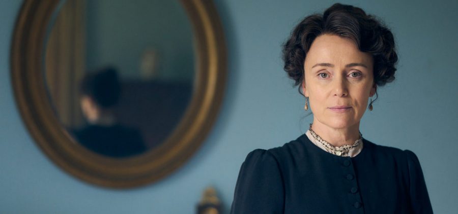 character from Miss Austen On Masterpiece in parlor with mirror behind her.
