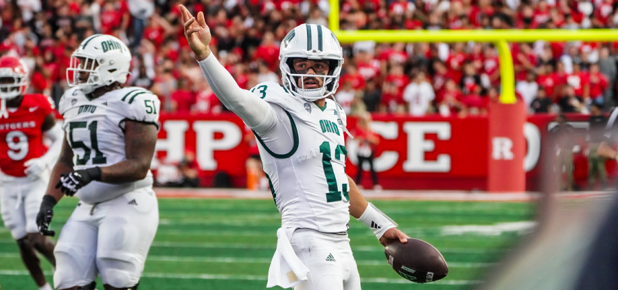 Ohio QB Parker Navarro pointing ahead after getting the Bobcats a first down vs Rutgers.